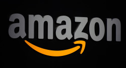 The Amazon logo is seen on a podium duri